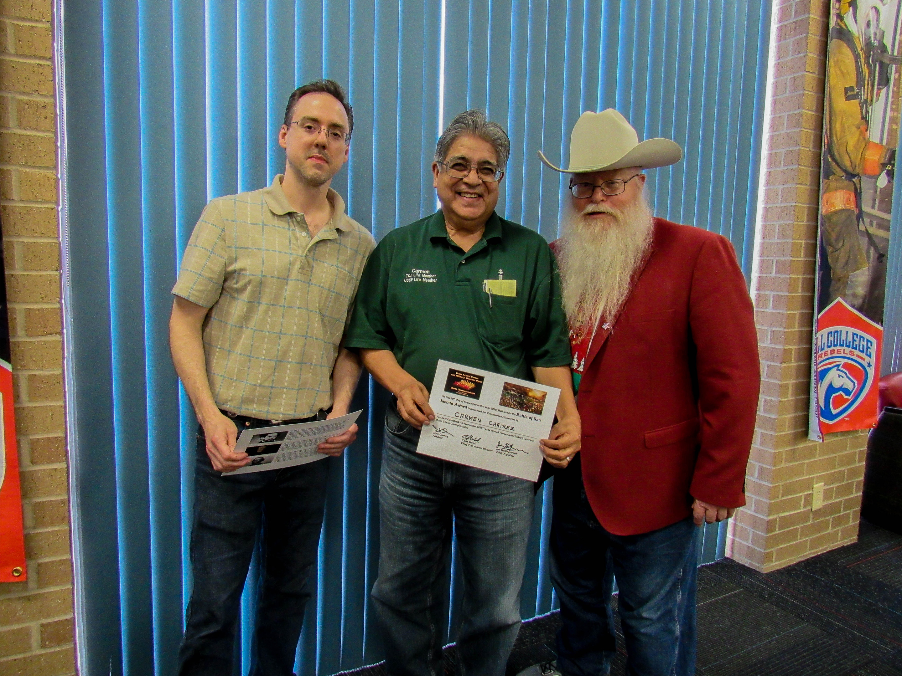 Carmen Chairez won the Battle of San Jacinto Award for playing an incredible Ruy Lopez Closed [C84] with the white pieces against a strong Navy veteran.  Games Judge Jeffrey Spyrison (left) and Chief Organizer Jim Hollingsworth (right) presented the award.  Photo by Sheryl McBroom.