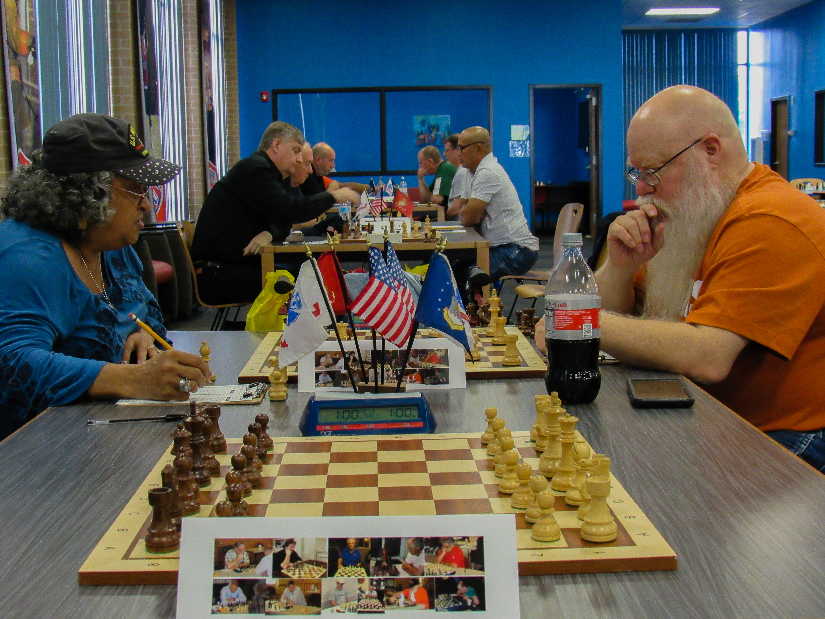 Round One battle between top Marine (Clarese Roberts -left) and top Soldier (Jim Hollingsworth - right) in the Fort Worth Veterans Chess Club.  Photo by Sheryl McBroom.