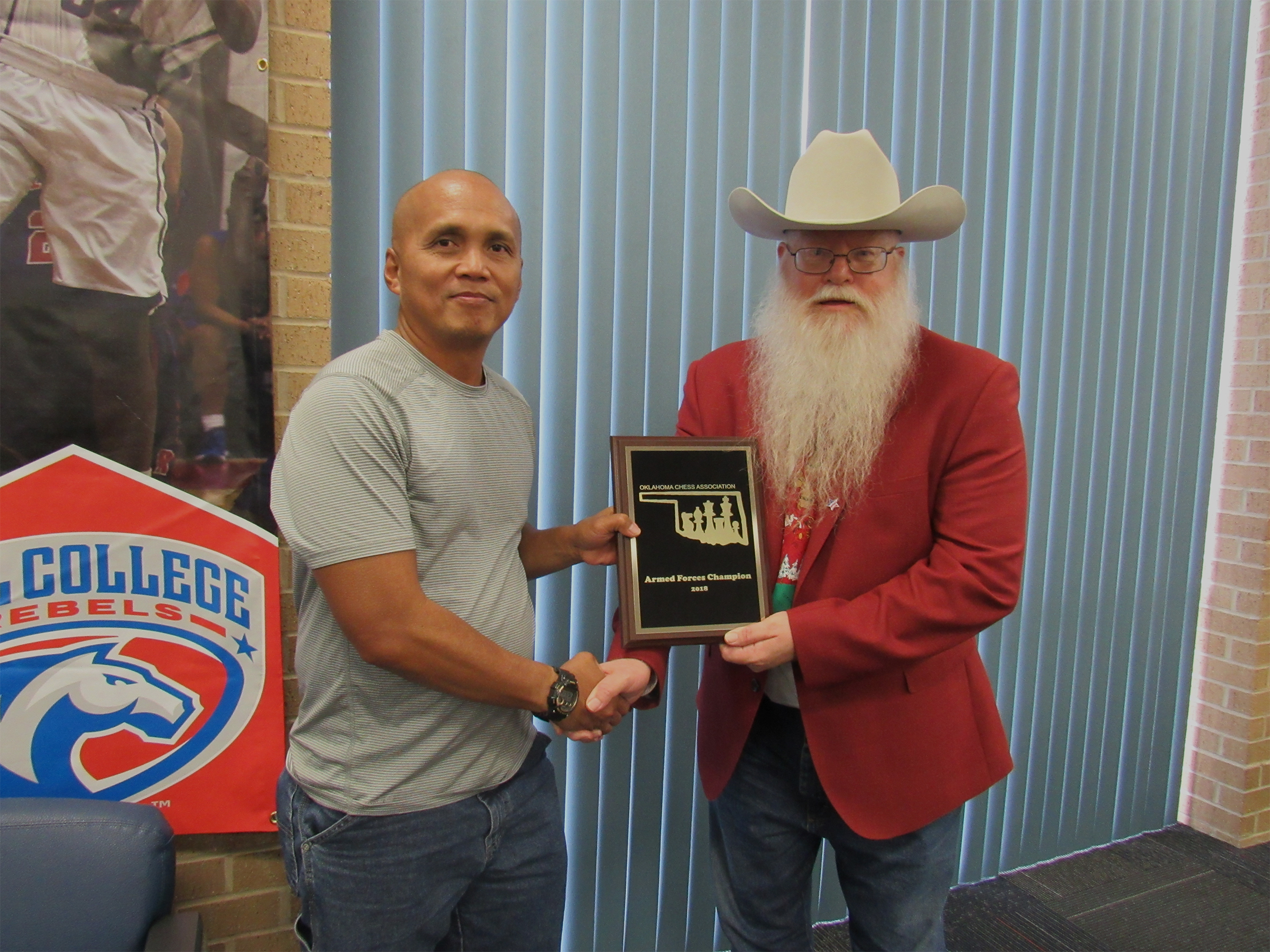 Chess Expert Neal Naputo (left) receives the Oklahoma Armed Forces Champion title and award from Chief Organizer Jim Hollingsworth (right).  Photo by Sheryl McBroom.