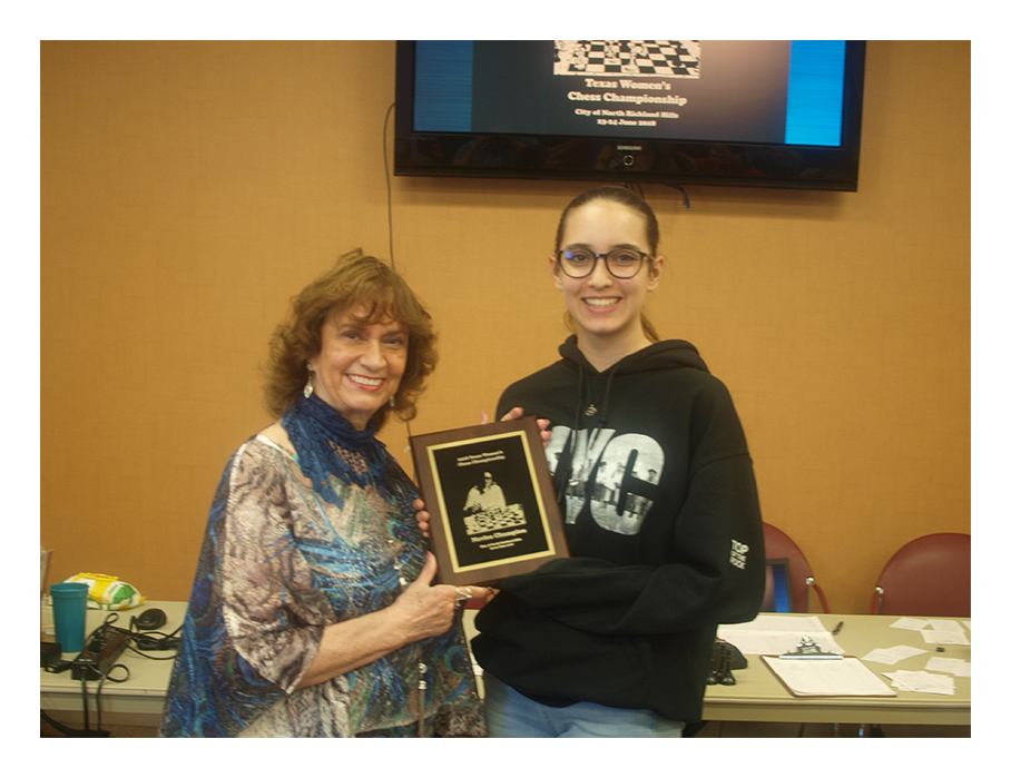 Maritta Del Rio Sumner presenting Texas Women's Novice award and title to Ambriette Reed