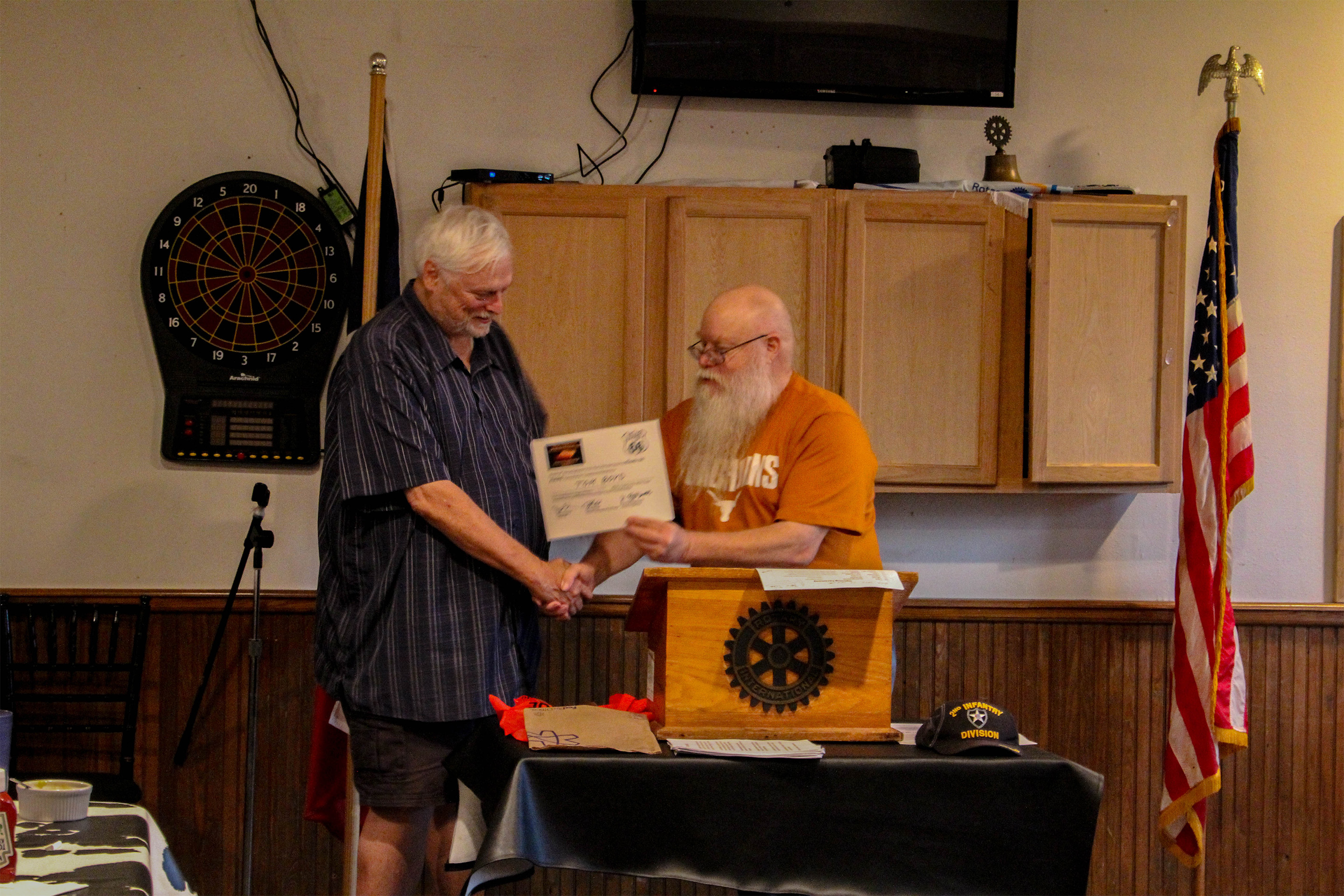 Tom Boyd traveled 1,792 miles to play in the 2019 Texas Armed Forces and Military Veterans Open Chess Championships (left in the photo).  Chief Organizer Jim Hollingsworth (right) presented his award at the Veterans Dinner.  Photo by Sheryl McBroom.